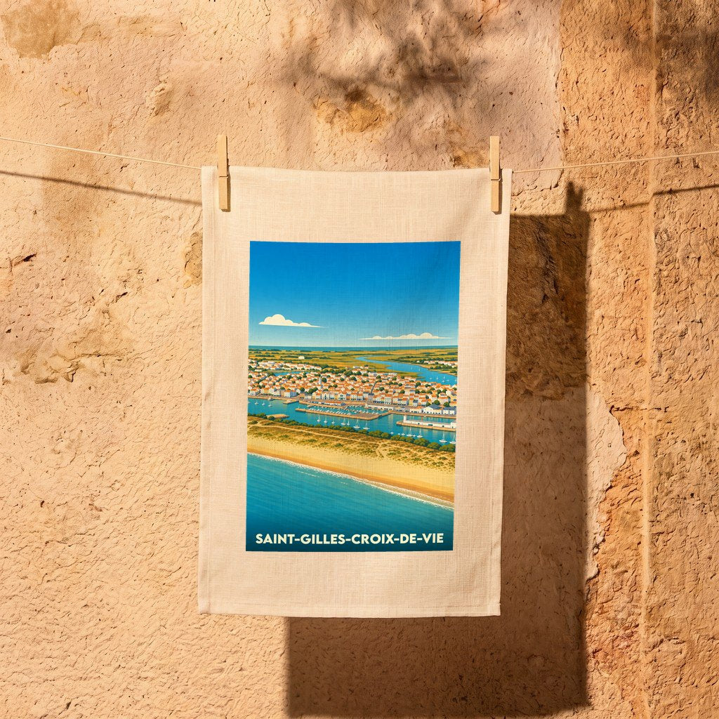 Torchon souvenir de la ville de Saint-Gilles-Croix-de-Vie avec une illustration stylisée du littoral et du port.