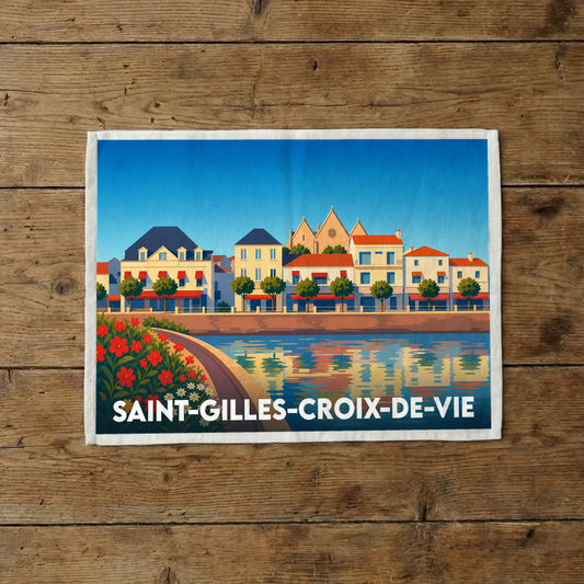 Torchon souvenir de la ville de Saint-Gilles-Croix-de-Vie avec une illustration stylisée du quai et de ses reflets.