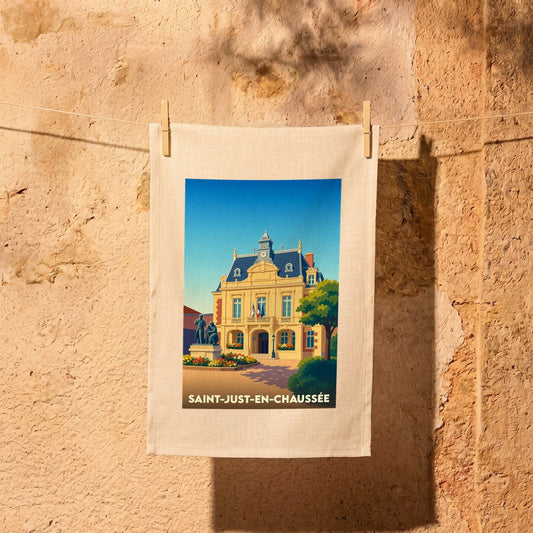 Torchon souvenir de la ville de Saint-Just-en-Chaussée avec une illustration stylisée de son hôtel de ville.