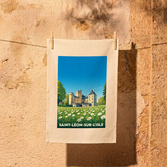 Torchon souvenir de la ville de Saint-Léon-sur-l'Isle avec une illustration stylisée d'un château entouré de marguerites.