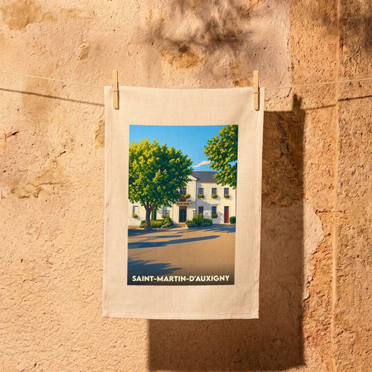 Torchon souvenir de la ville de Saint-Martin-d'Auxigny avec une illustration stylisée d'un bâtiment ensoleillé.