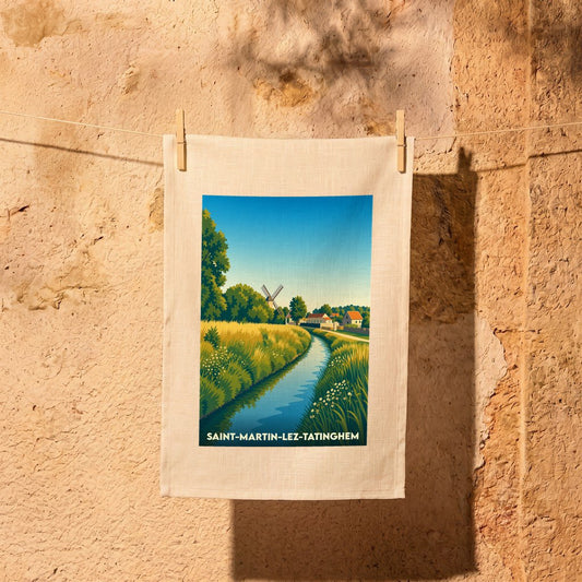 Torchon souvenir de la ville de Saint-Martin-lez-Tatinghem avec une illustration stylisée d'un paysage bucolique.