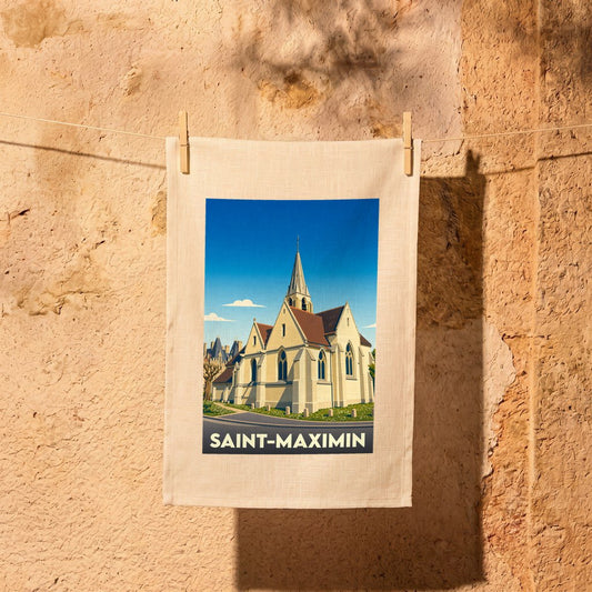 Torchon souvenir de la ville de Saint-Maximin avec une illustration stylisée d'une église sous un ciel bleu.