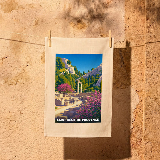 Torchon souvenir de la ville de Saint-Rémy-de-Provence illustré d'un paysage stylisé de ruines antiques dans un décor provençal.