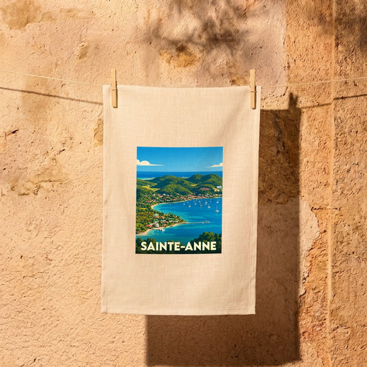 Torchon souvenir de la ville de Sainte-Anne orné d'une illustration stylisée de sa baie tropicale.