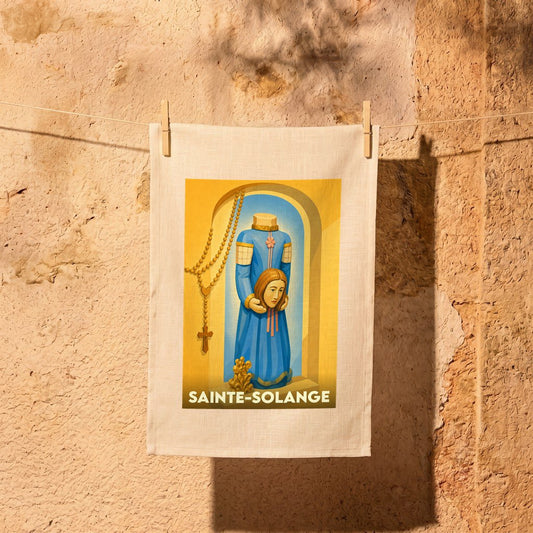 Torchon souvenir de la ville de Sainte-Solange avec une illustration stylisée d'une sainte céphalophore.