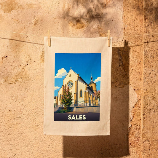 Torchon souvenir de la ville de Sales avec une illustration stylisée de son église.