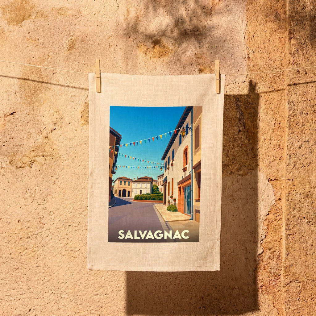 Torchon souvenir de la ville de Salvagnac illustré d'une scène de rue pittoresque et colorée.