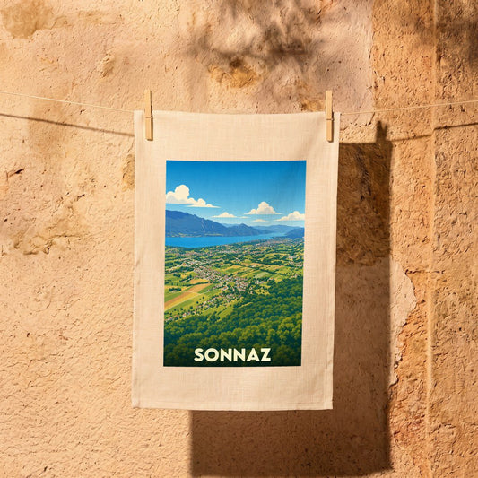 Torchon souvenir de la ville de Sonnaz illustré d'un paysage panoramique stylisé.