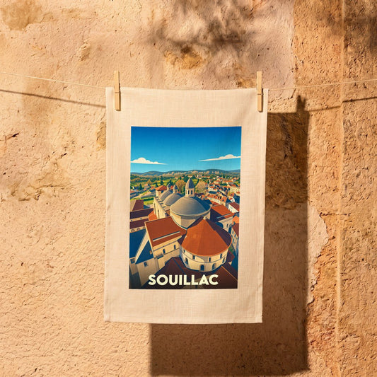 Torchon souvenir de la ville de Souillac avec une illustration stylisée de son abbaye et de ses toits.