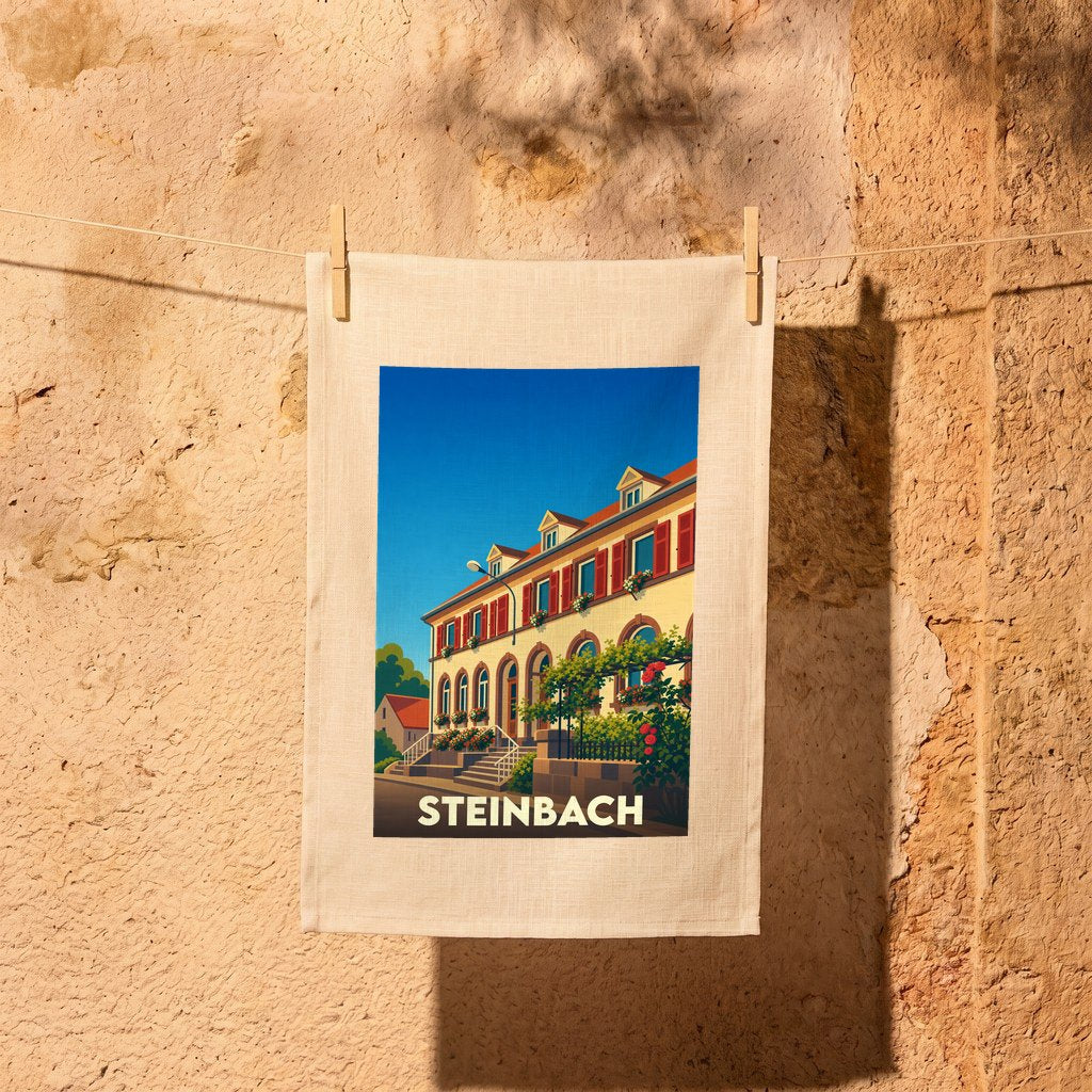 Torchon souvenir de la ville de Steinbach orné d'une illustration stylisée de son architecture locale.