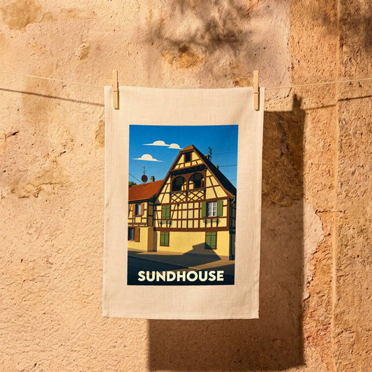 Torchon souvenir de la ville de Sundhouse avec une illustration stylisée d'une maison à colombages.
