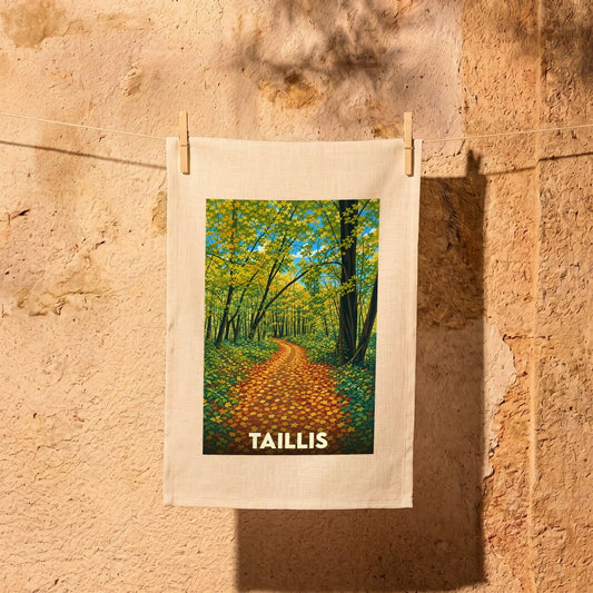 Torchon souvenir de la ville de Taillis avec une illustration stylisée d'un chemin forestier en automne.