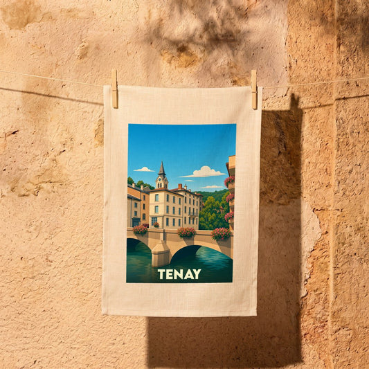 Torchon souvenir de la ville de Tenay illustré par un paysage stylisé de pont et de maisons colorées.