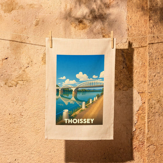 Torchon souvenir de la ville de Thoissey avec une illustration stylisée d'un pont enjambant une rivière.