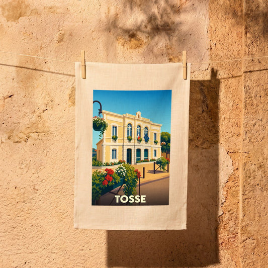 Torchon souvenir de la ville de Tosse orné d'une illustration stylisée de sa mairie fleurie.