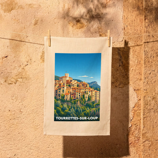 Torchon souvenir de la ville de Tourrettes-sur-Loup avec une illustration stylisée du village perché.