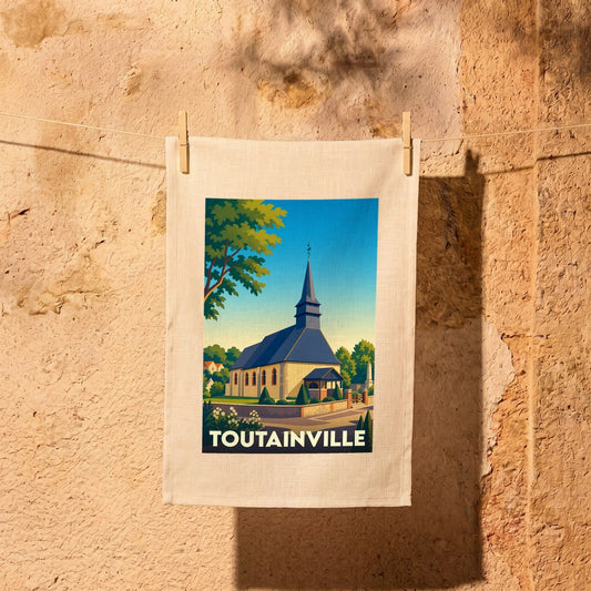 Torchon souvenir de la ville de Toutainville illustré d'une église de style normand.