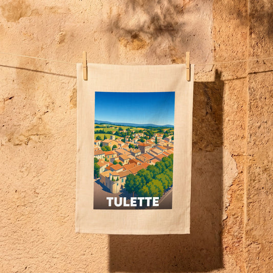 Torchon souvenir de la ville de Tulette avec une illustration stylisée de ses toits et de ses paysages.