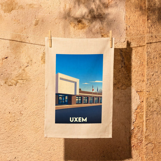 Torchon souvenir de la ville de Uxem avec une illustration stylisée de sa mairie.