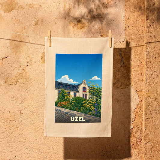 Torchon souvenir de la ville d'Uzel orné d'une illustration stylisée de son architecture et de sa végétation.