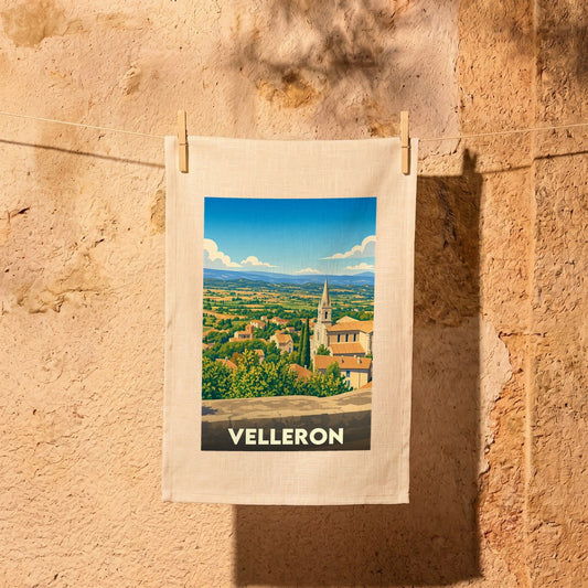 Torchon souvenir de la ville de Velleron avec une illustration stylisée d'un paysage provençal.
