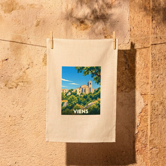 Torchon souvenir de la ville de Viens avec une illustration stylisée d'un village perché.