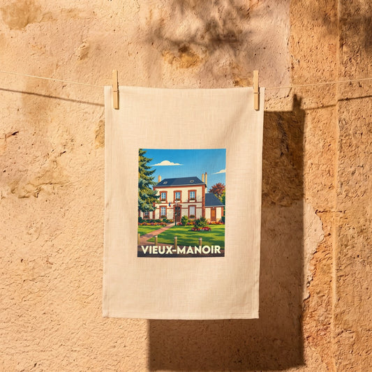 Torchon souvenir de la ville de Vieux-Manoir avec une illustration stylisée.