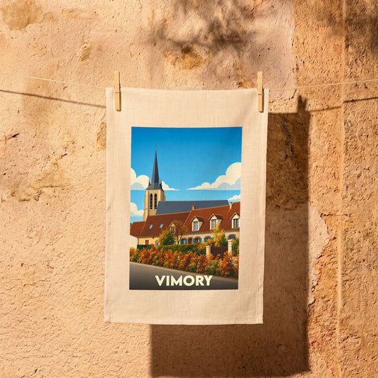 Torchon souvenir de la ville de Vimory illustré par une vue stylisée de son église et de maisons fleuries.