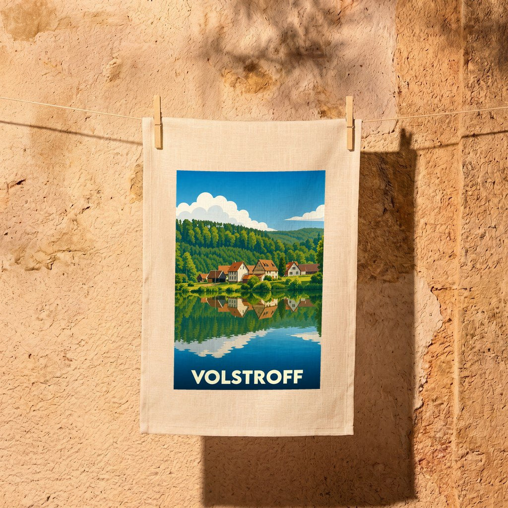 Torchon souvenir de la ville de Volstroff orné d'une illustration stylisée d'un paysage lacustre.