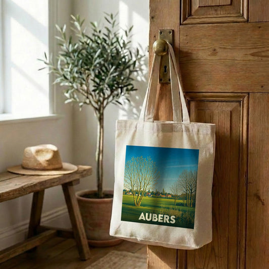 Tote bag souvenir de la ville d’Aubers avec une illustration stylisée de paysages ruraux.