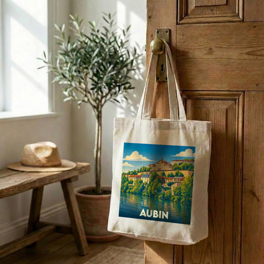Tote bag souvenir de la ville d'Aubin avec une illustration stylisée de son paysage au bord de l'eau.