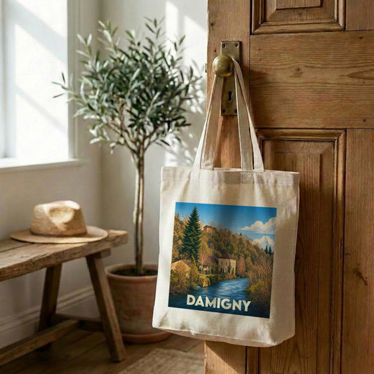 Tote bag souvenir de la ville de Damigny avec une illustration paysagère stylisée.