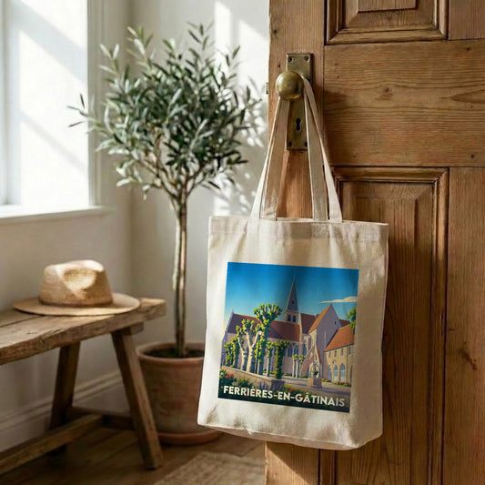 Tote bag souvenir de la ville de Ferrières-en-Gâtinais avec une illustration stylisée d'une abbaye.