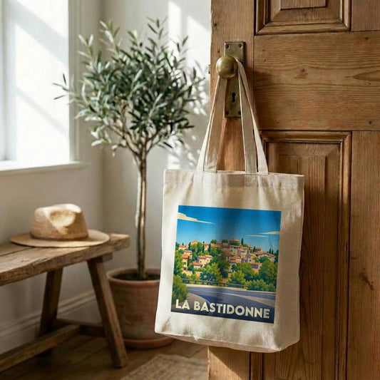 Tote bag souvenir de la ville de La Bastidonne avec une illustration de paysage stylisée.