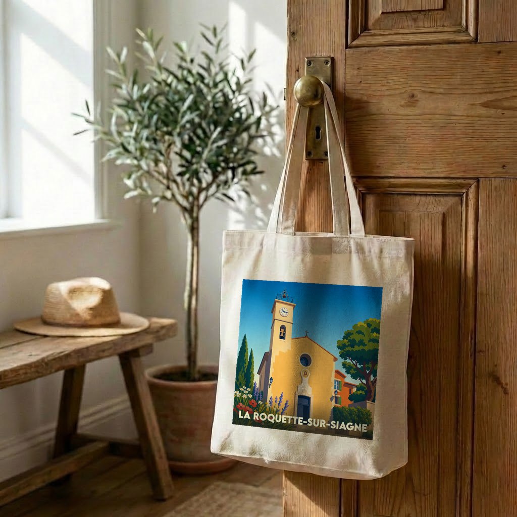Tote bag souvenir de la ville de La Roquette-sur-Siagne avec une illustration stylisée d'une église provençale.