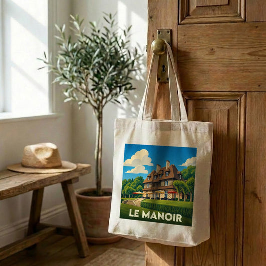 Sac cabas souvenir de la ville de Le Manoir avec une illustration stylisée d'un manoir normand.