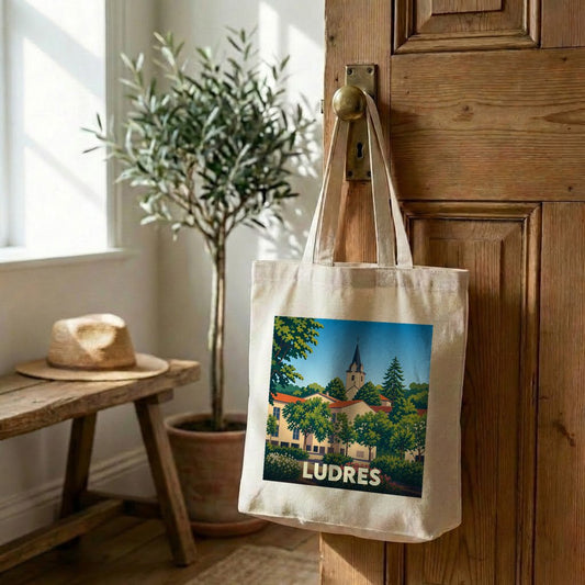 Tote bag souvenir de la ville de Ludres avec une illustration stylisée.