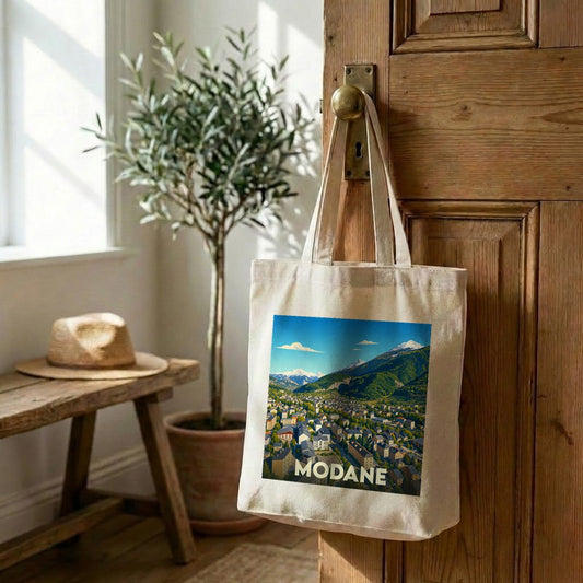 Tote bag souvenir de la ville de Modane avec une illustration de paysage de montagne.