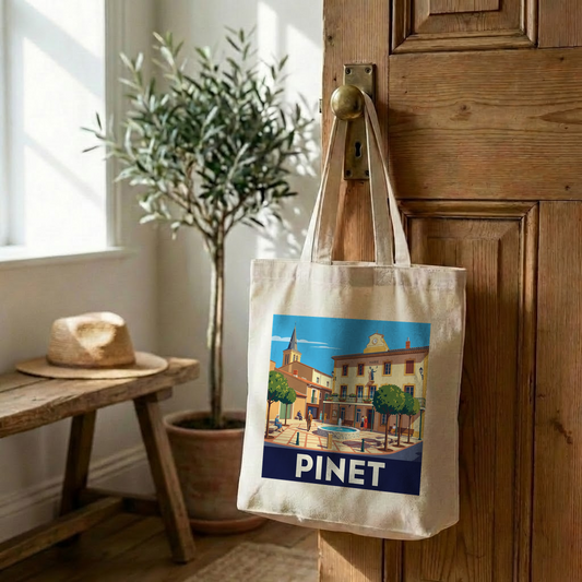 Tote bag souvenir de la ville de Pinet avec une illustration stylisée.