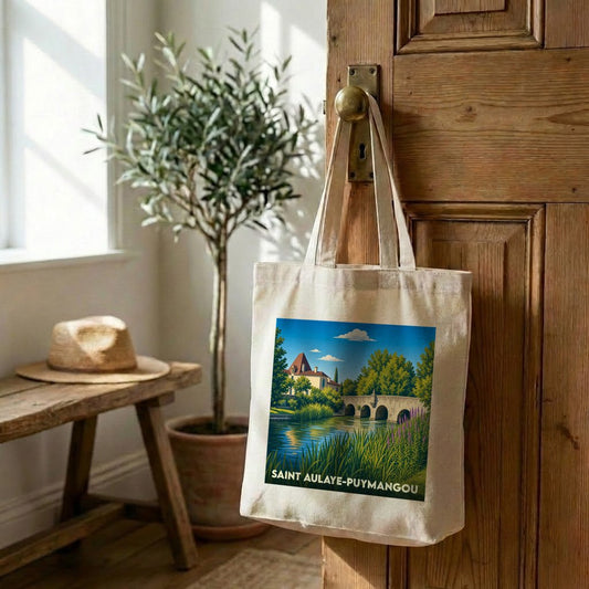 Tote bag souvenir de la ville de Saint Aulaye-Puymangou avec une illustration stylisée de son pont et de son château au bord de l'eau.