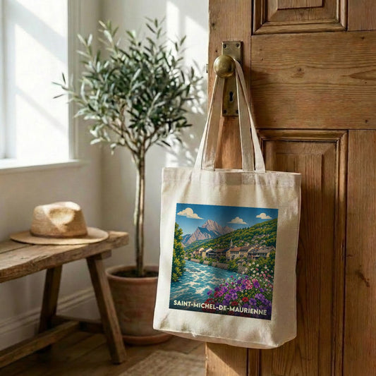 Tote bag souvenir de la ville de Saint-Michel-de-Maurienne avec une illustration stylisée de montagne et de rivière.